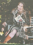 danish B.T. 27. Oct. 2003 - on a ladder, wears wool-coat, skirt, Karla book in hands